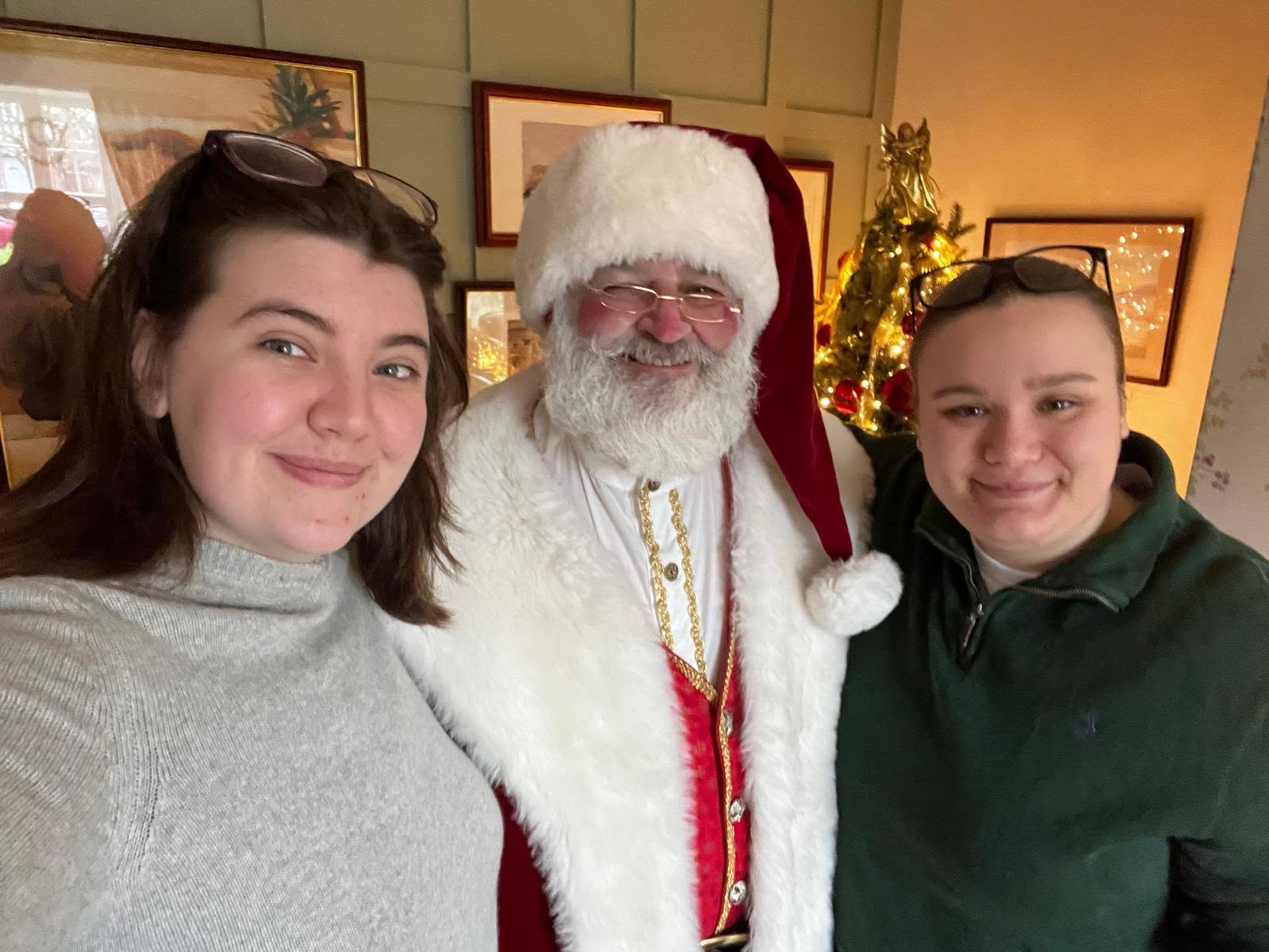 The Real Bearded Santa smiling with two visitors